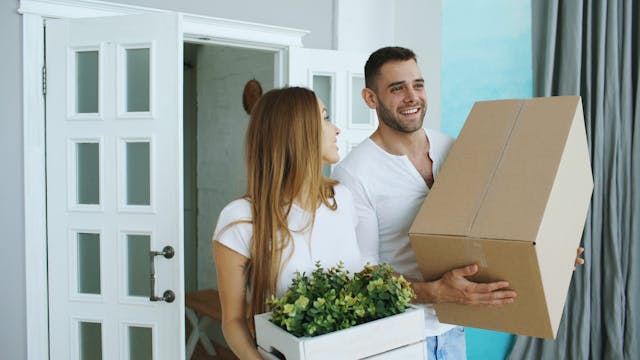 two people moving into a home