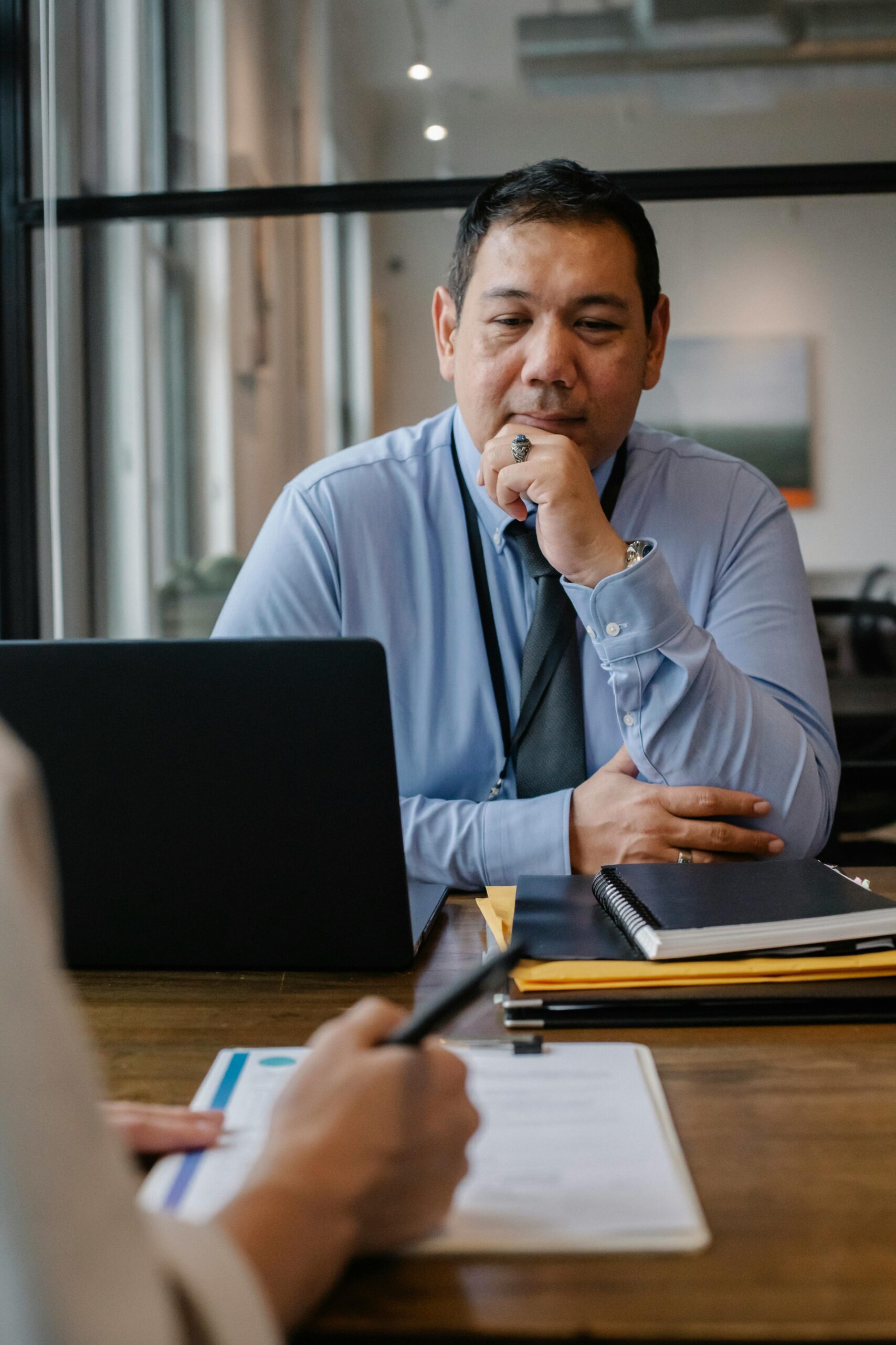 Businessman engaged in a focused meeting, contemplating documents
