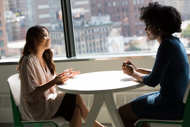 two people talking at a table