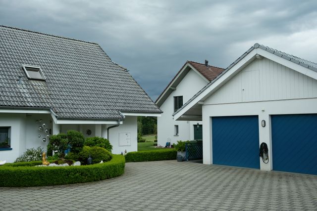 a garage next to a suburban home