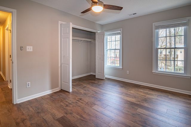 an empty room with a ceiling fan
