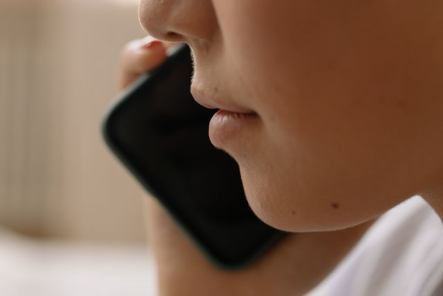 a person holding their phone up to their ear